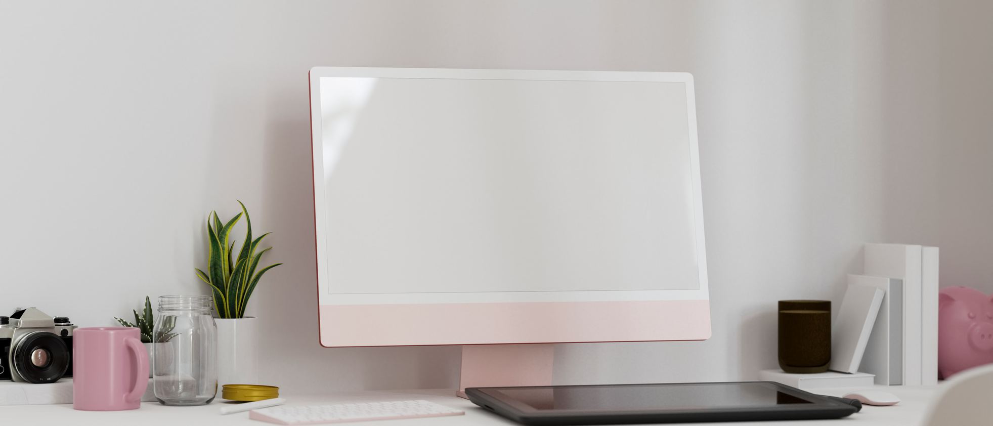 Modern feminine workspace with pink computer and decor